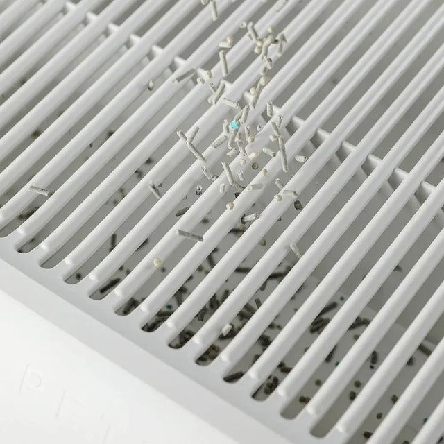 detail van een petkit kattenbakvulling opvangbak